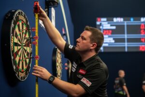 Player checking official dartboard height during setup.